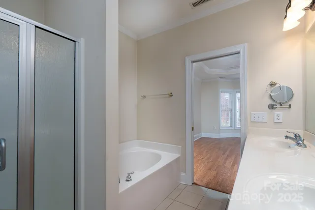 a bathroom with a tub shower and sink