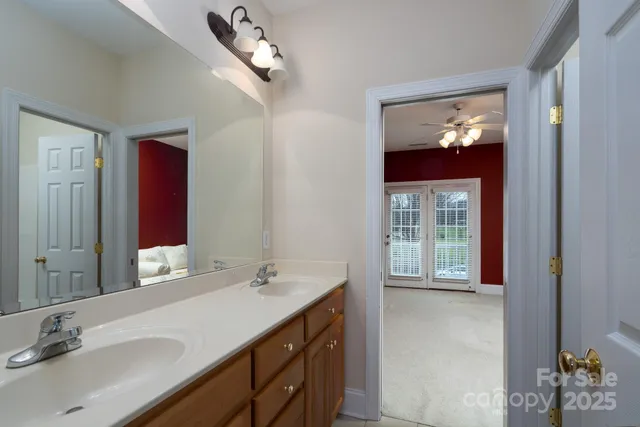 a bathroom with a double vanity sink and a mirror