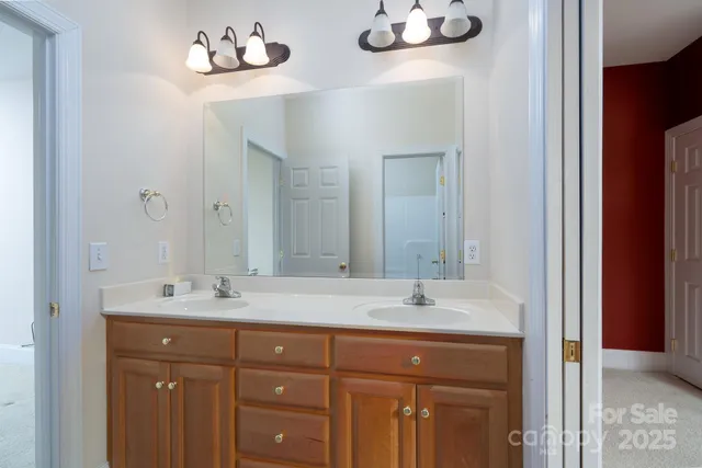 a bathroom with a sink double vanity and a mirror