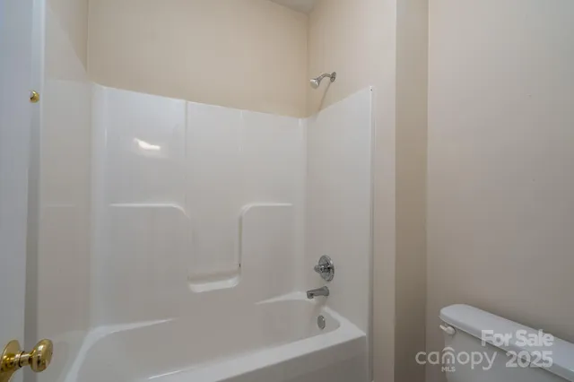 a bathroom with a bathtub and toilet