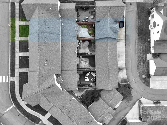 an aerial view of residential houses with outdoor space