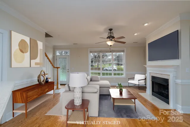 a living room with fireplace furniture and a flat screen tv