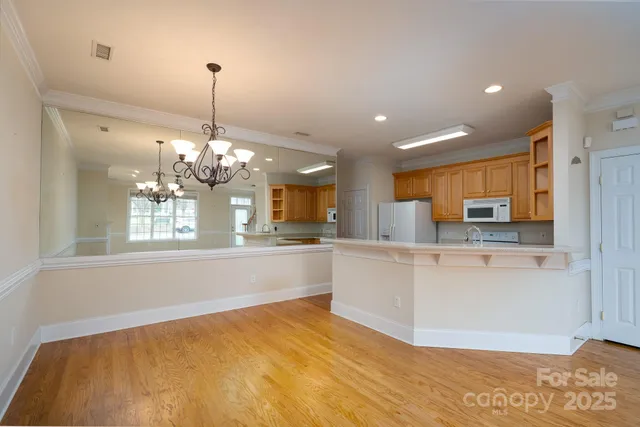a large kitchen with kitchen island a sink stainless steel appliances and cabinets
