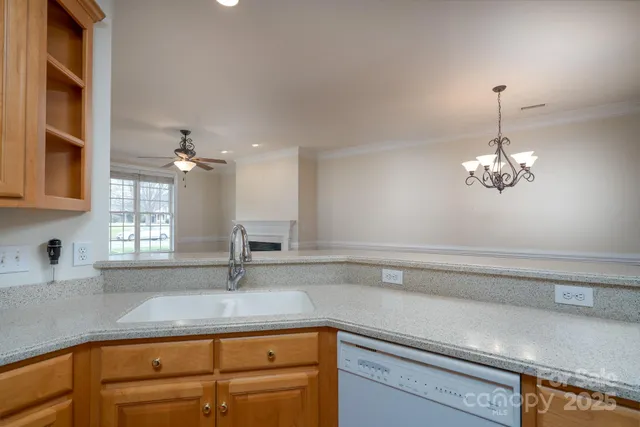 a kitchen with a sink and chandelier
