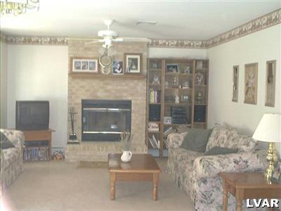 21 Roman Road Kunkletown, PA 18058 - Photo 3 of 8 a living room with furniture a fireplace and a dining table