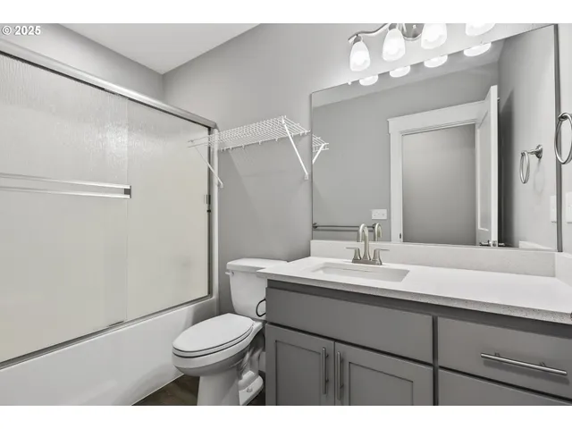 a bathroom with a sink vanity mirror and toilet
