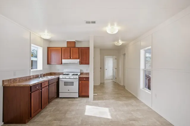a view of a kitchen with a stove top oven