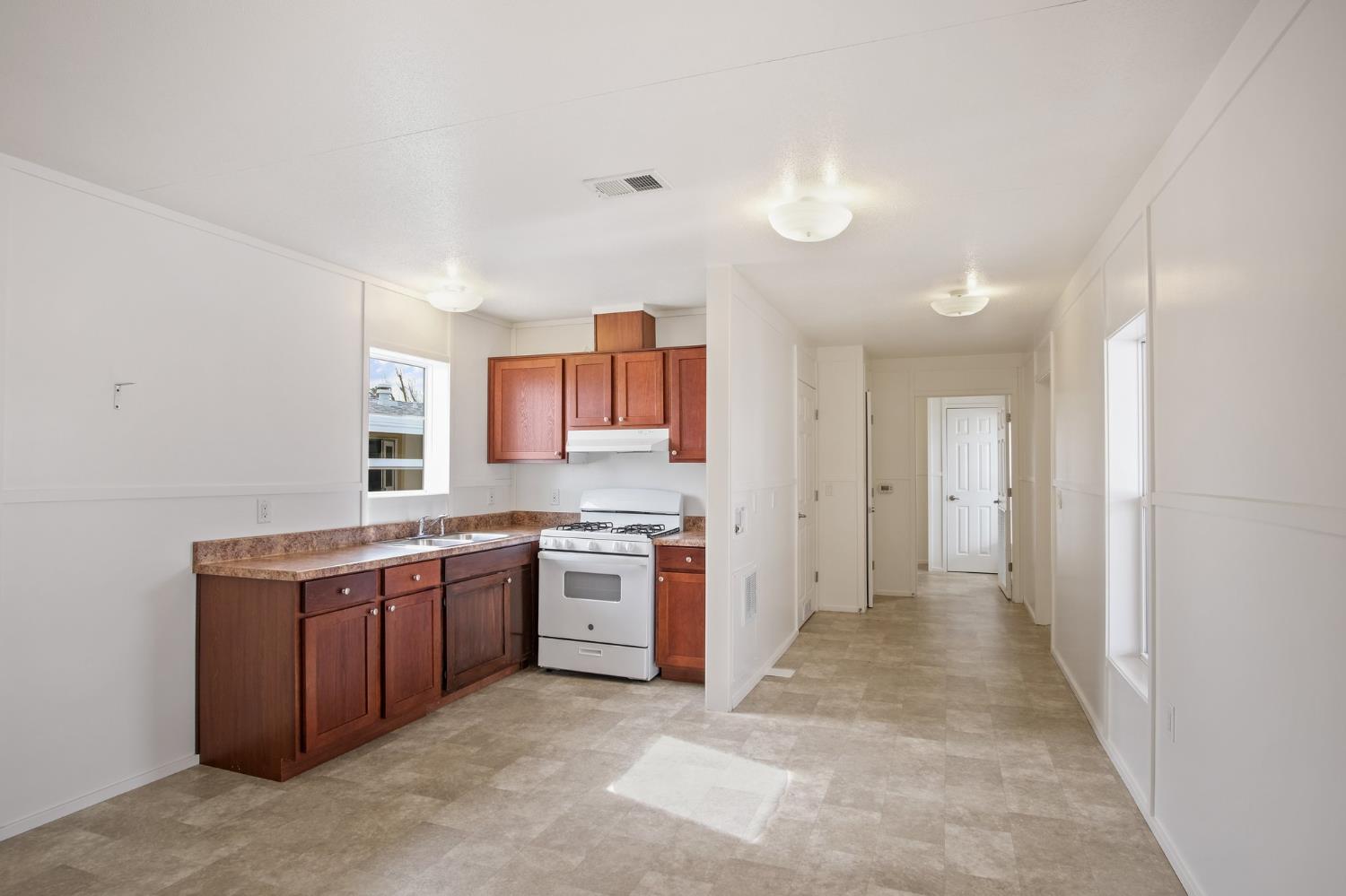 1400 Meredith Avenue, Unit 81 Gustine, CA 95322 - Photo 19 of 29 a view of a kitchen with a stove top oven