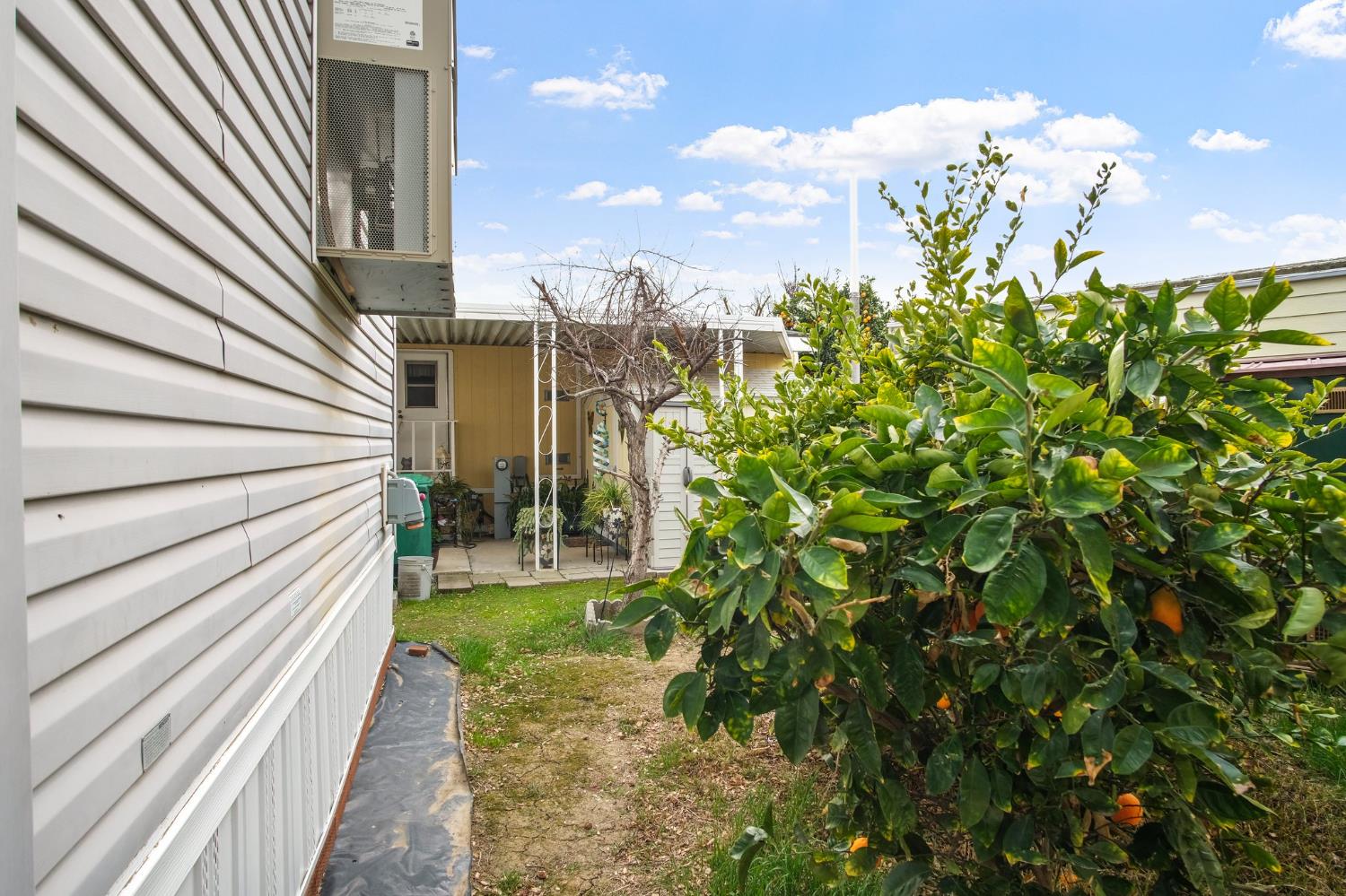 1400 Meredith Avenue, Unit 81 Gustine, CA 95322 - Photo 24 of 29 a view of a pathway of a house with wooden fence