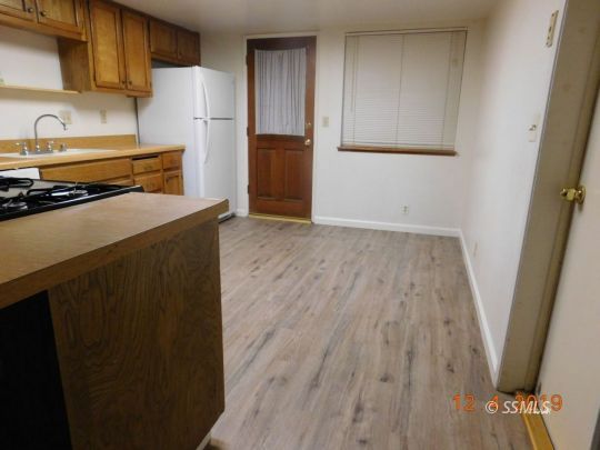 712 North Florence Street Ridgecrest, CA 93555 - Photo 7 of 14 a kitchen with a refrigerator and a sink
