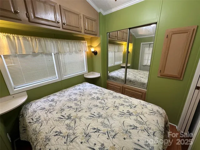 a bedroom with a bed and a mirror