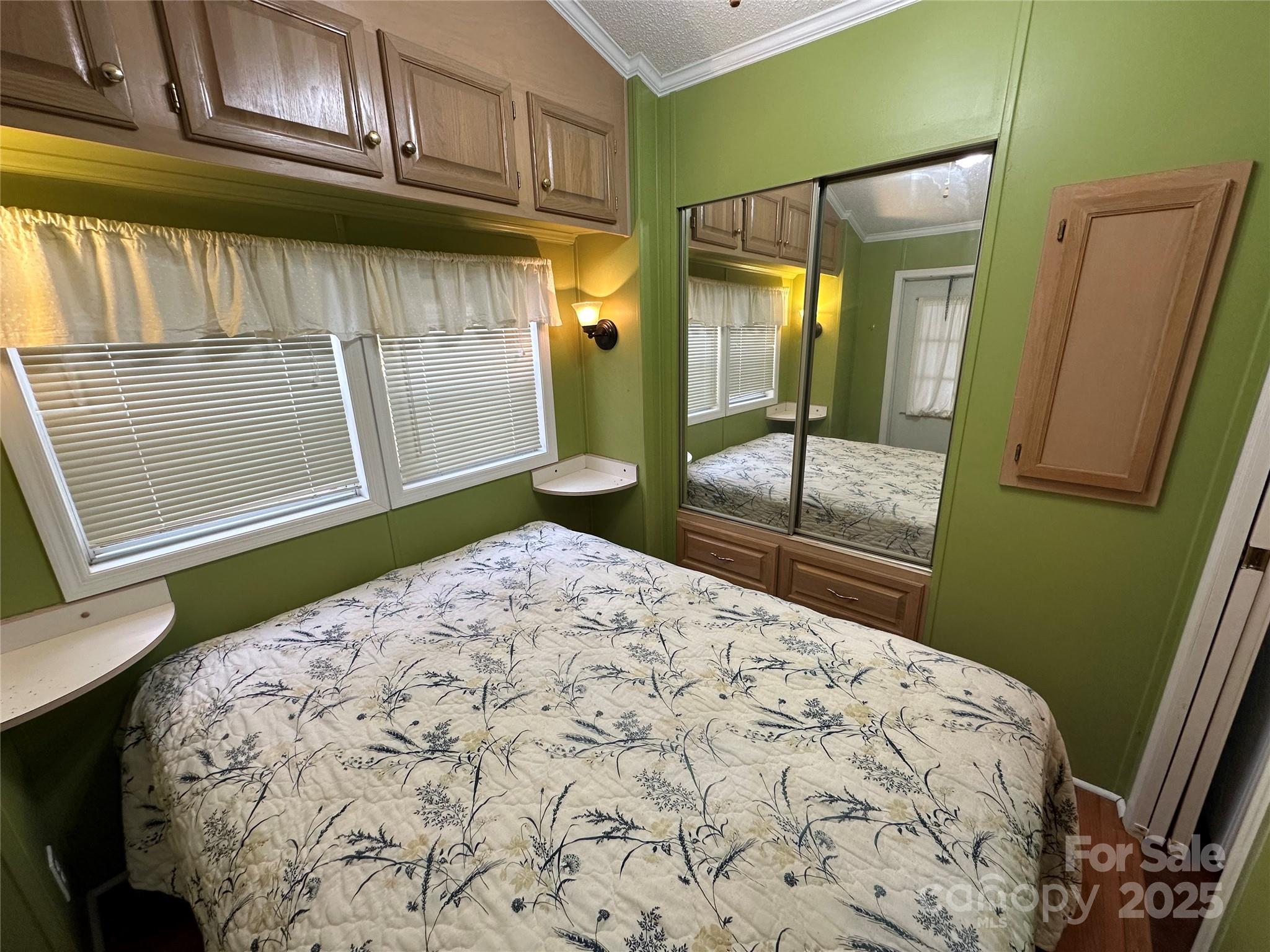 124 Hummingbird Circle New London, NC 28127 - Photo 14 of 48 a bedroom with a bed and a mirror