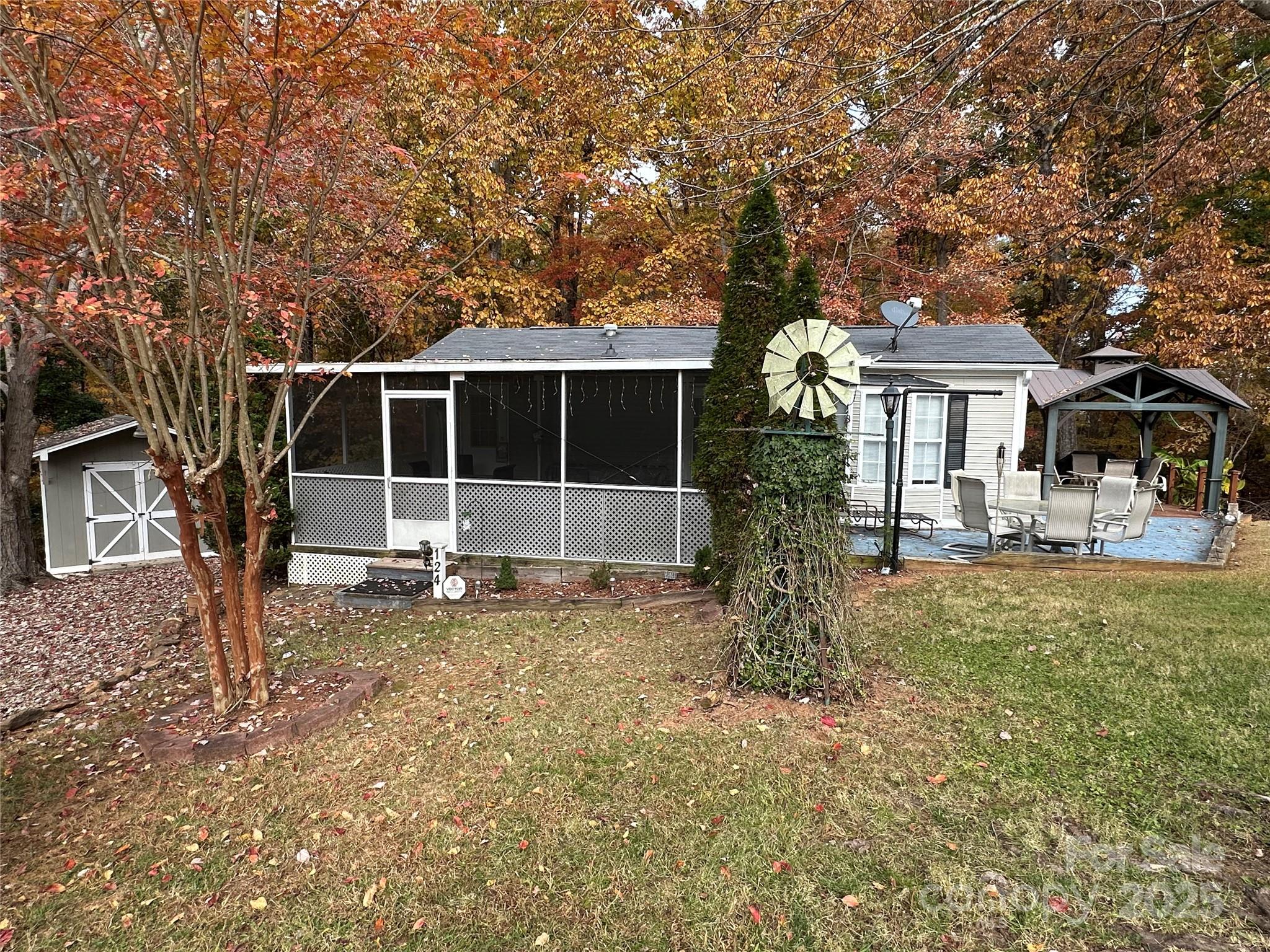 124 Hummingbird Circle New London, NC 28127 - Photo 2 of 48 a front view of a house with a garden and yard