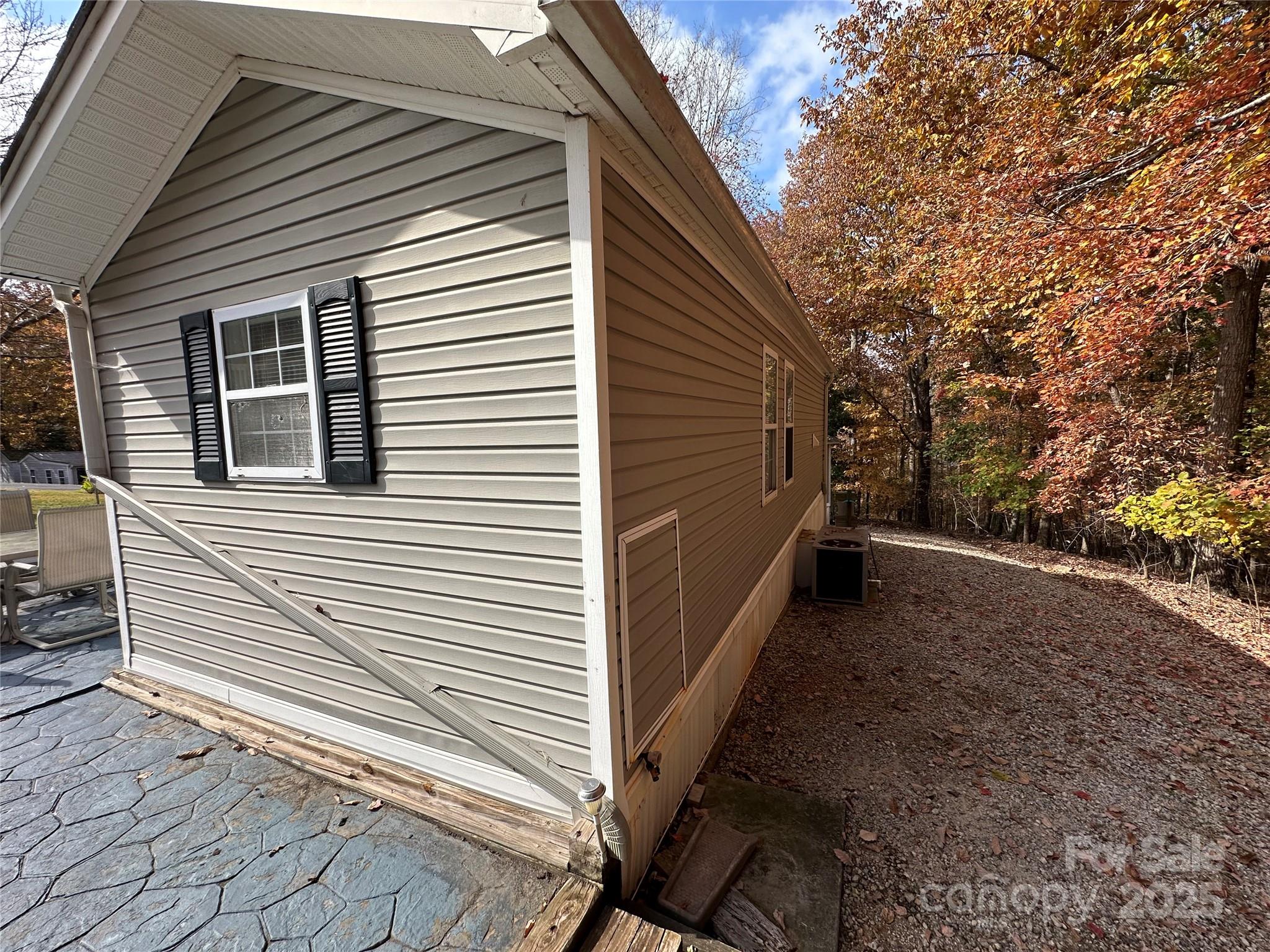 124 Hummingbird Circle New London, NC 28127 - Photo 22 of 48 a view of a house with backyard and trees