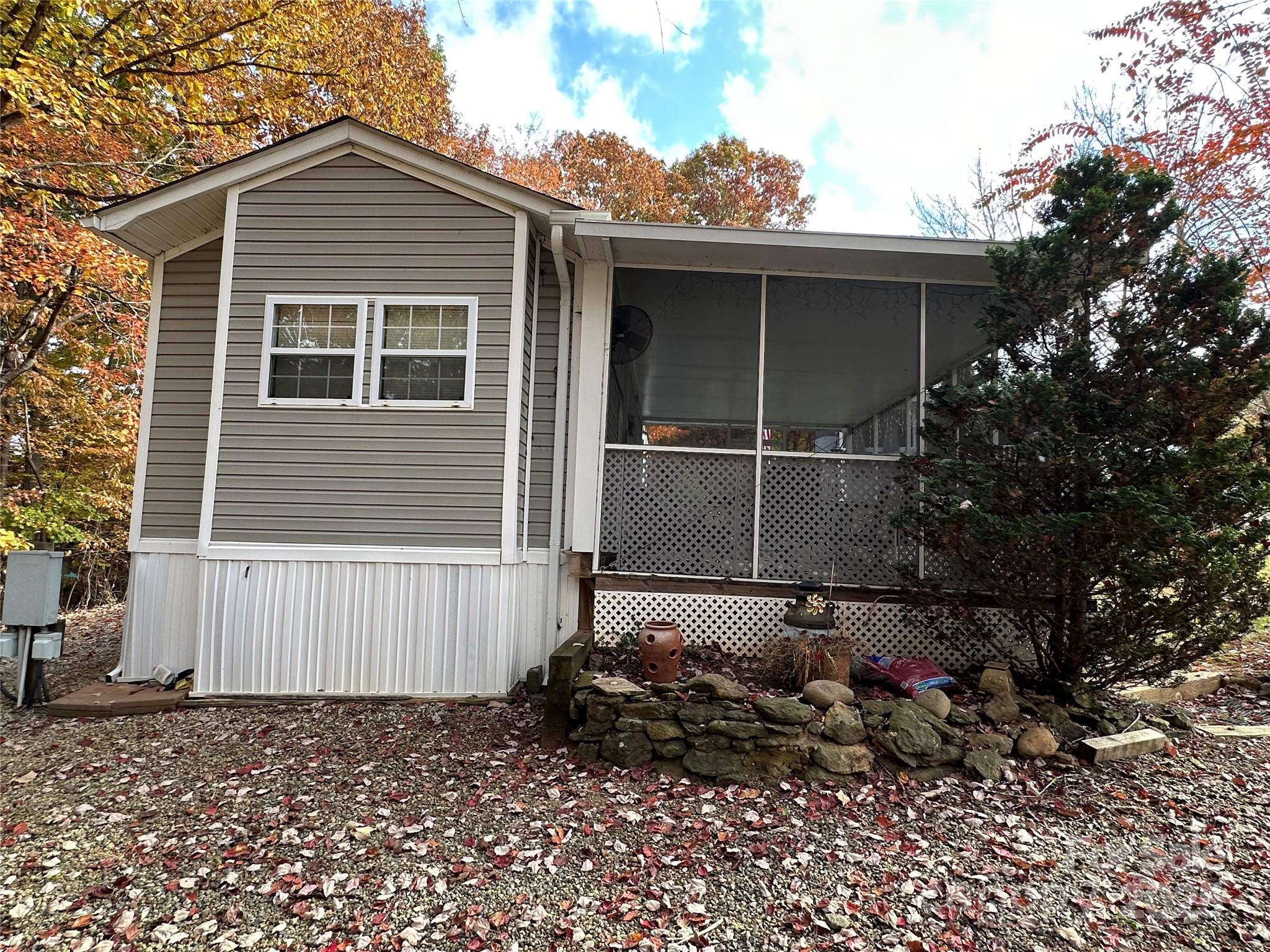124 Hummingbird Circle New London, NC 28127 - Photo 24 of 48 a house with a tree in the background