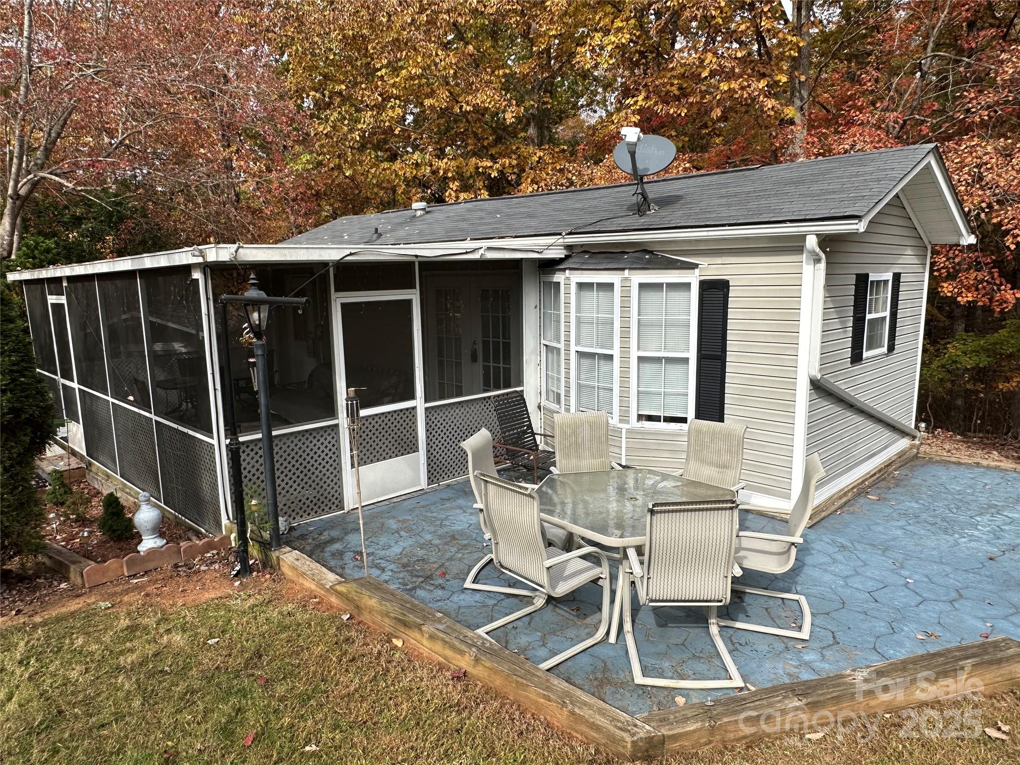 124 Hummingbird Circle New London, NC 28127 - Photo 3 of 48 a view of a patio with table and chairs and wooden fence