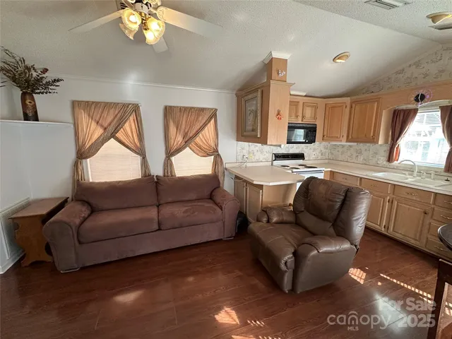 a living room with furniture a chandelier and a window