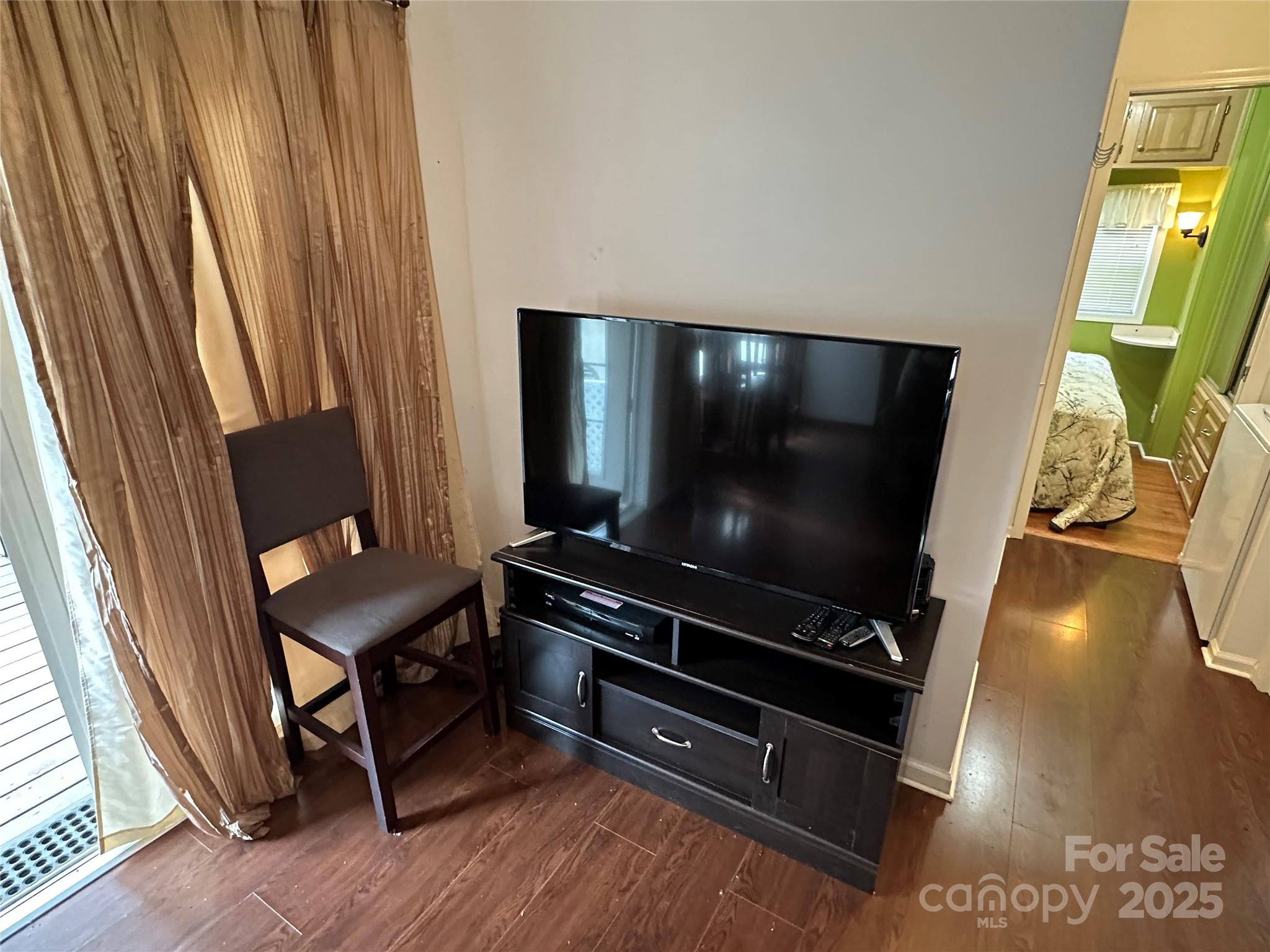 124 Hummingbird Circle New London, NC 28127 - Photo 5 of 48 a room with furniture and flat screen tv