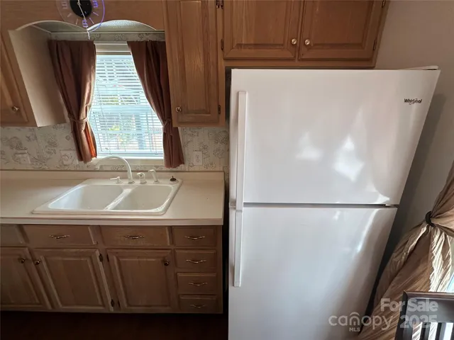 a view of walk in closet with window and door