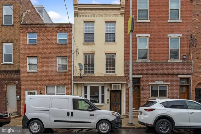 a front view of a house with parking space