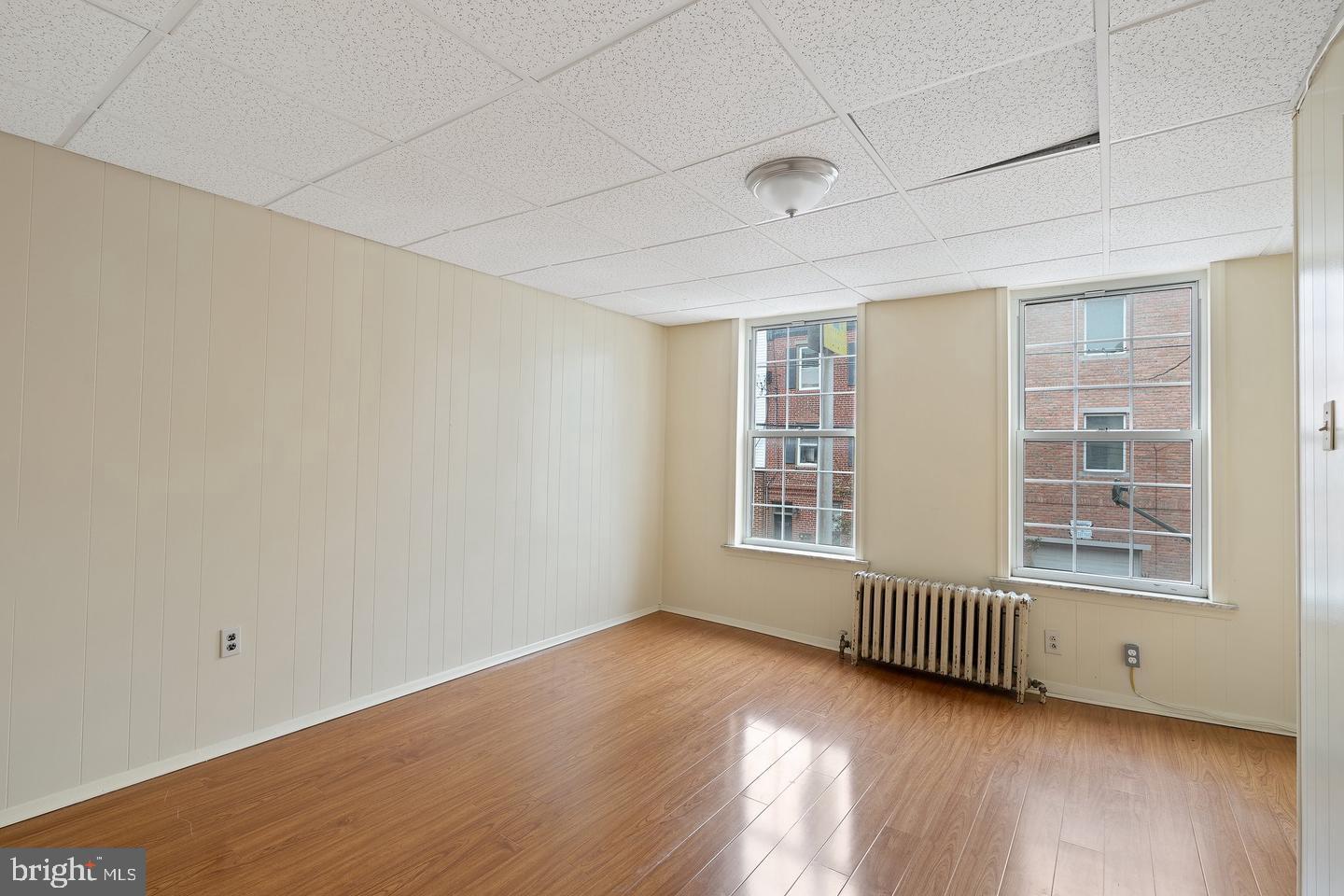 1225 South 2nd Street Philadelphia, PA 19147 - Photo 14 of 23 an empty room with wooden floor and windows