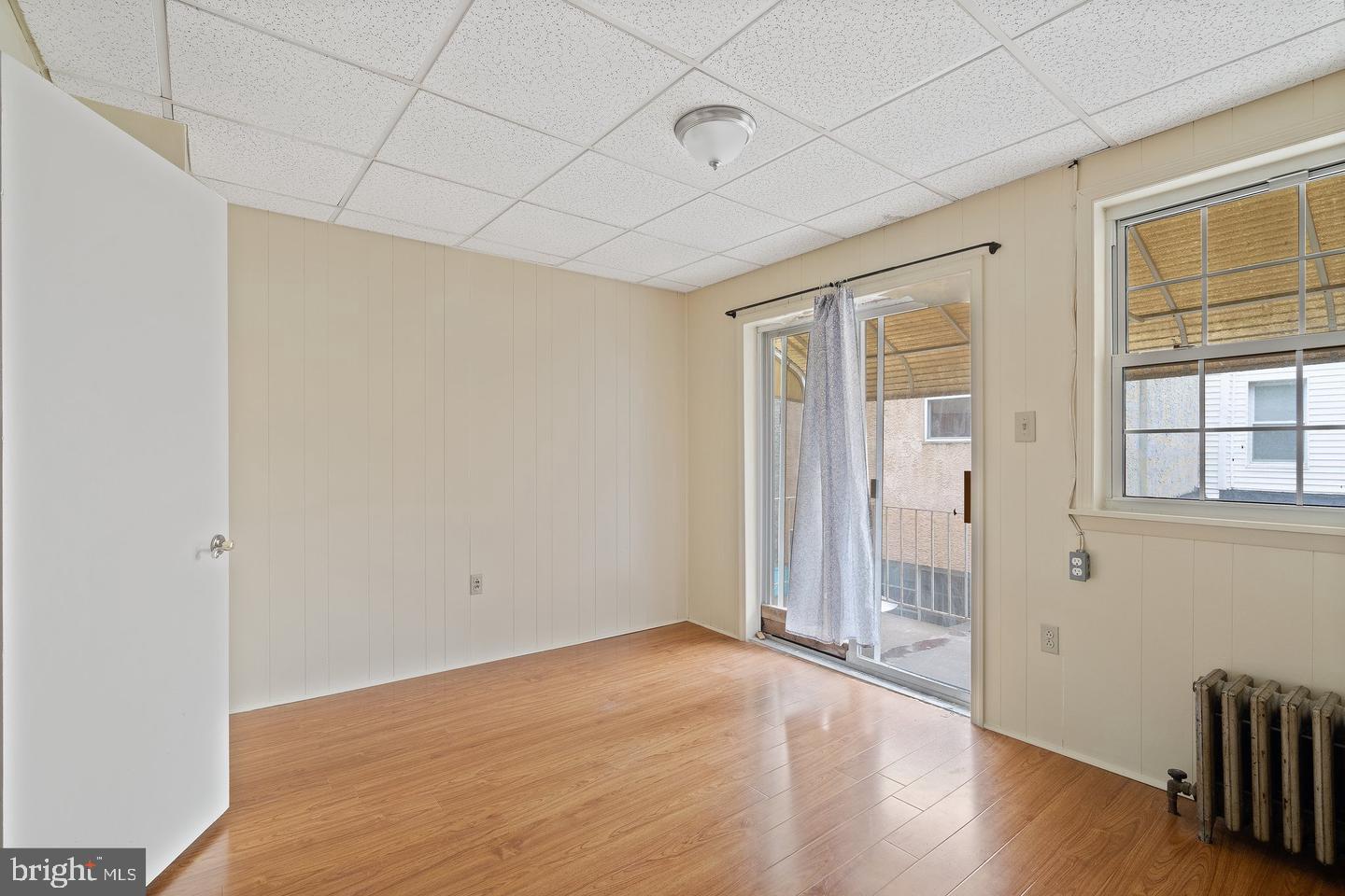 1225 South 2nd Street Philadelphia, PA 19147 - Photo 20 of 23 an empty room with wooden floor and windows