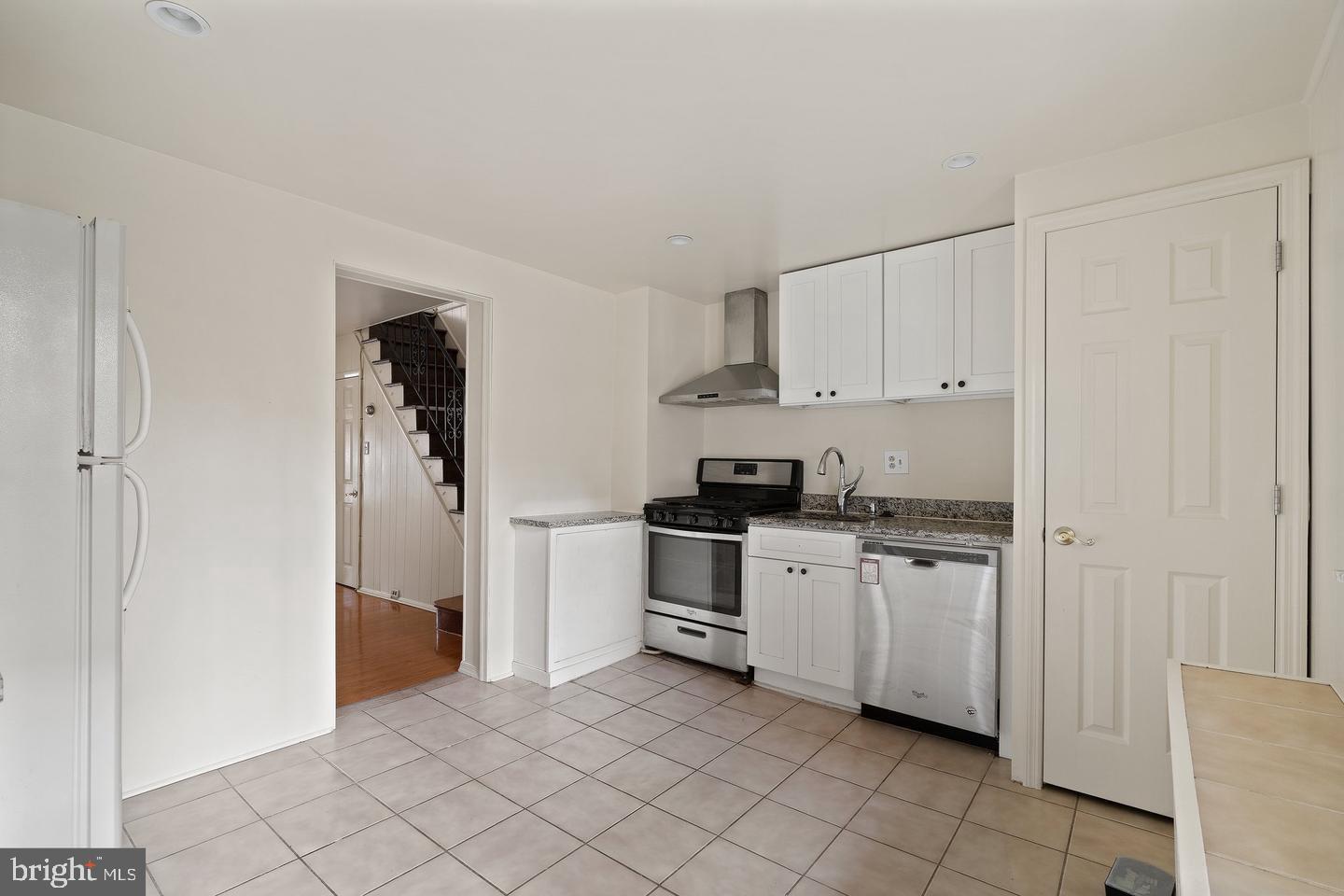1225 South 2nd Street Philadelphia, PA 19147 - Photo 6 of 23 a kitchen with white cabinets a sink dishwasher and a stove