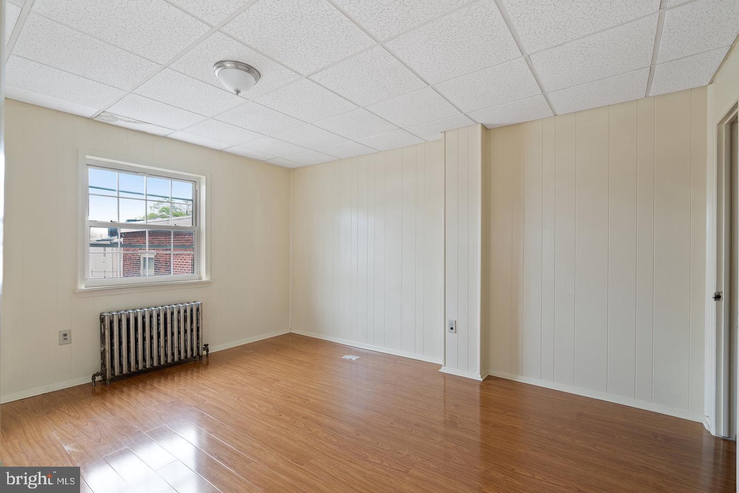 1225 South 2nd Street Philadelphia, PA 19147 - Photo 10 of 23 a view of an empty room with window and wooden floor