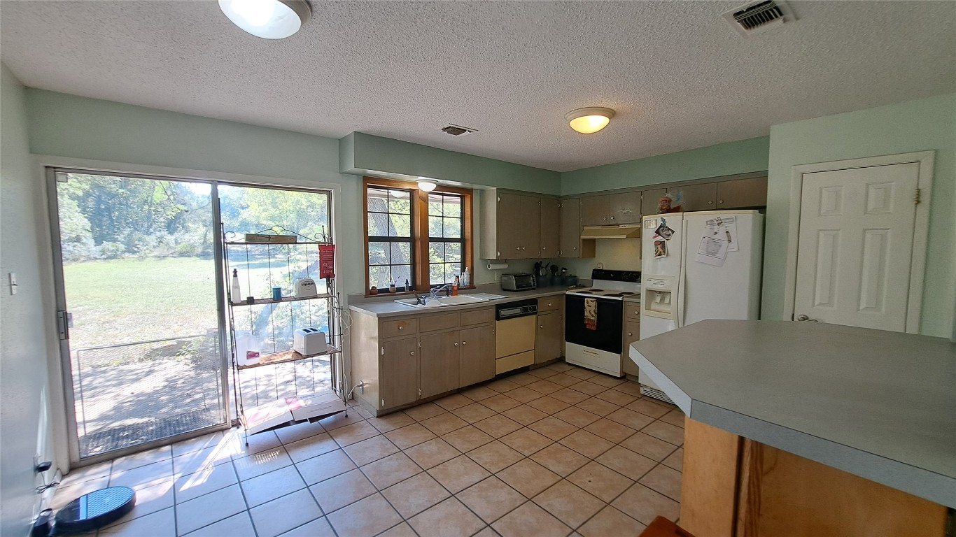9005 Dorella Lane Austin, TX 78736 - Photo 11 of 38 a large kitchen with a large window