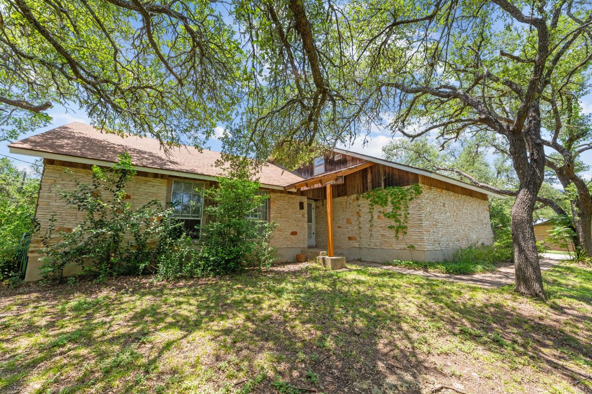 9005 Dorella Lane Austin, TX 78736 - Photo 2 of 38 a house is sitting in middle of forest