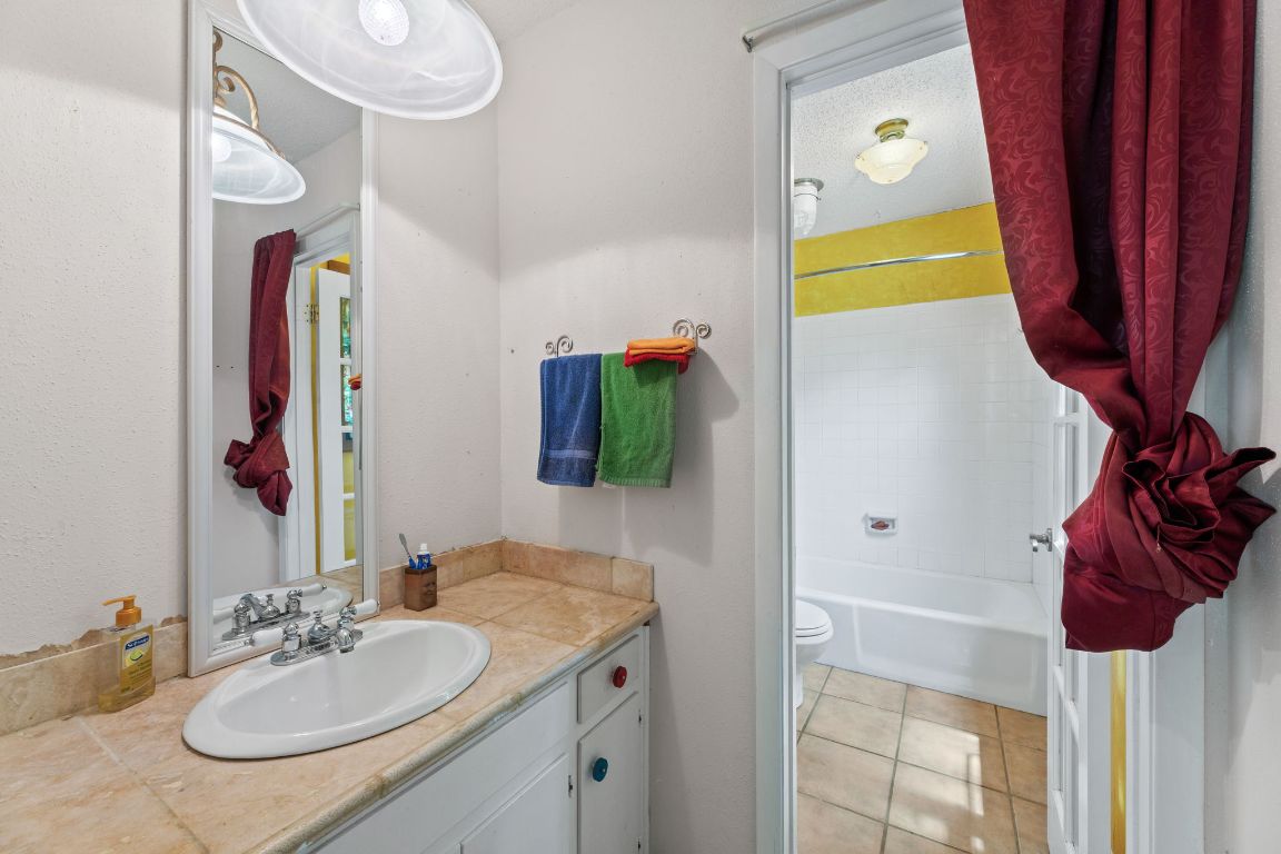 9005 Dorella Lane Austin, TX 78736 - Photo 23 of 38 a bathroom with a sink vanity and a mirror