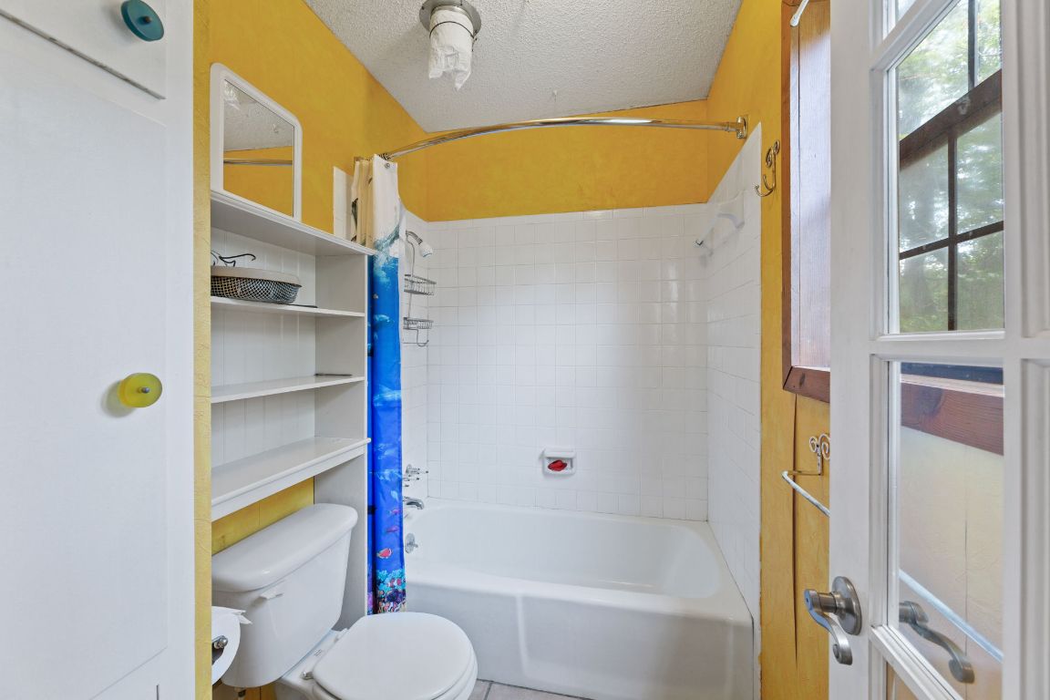 9005 Dorella Lane Austin, TX 78736 - Photo 24 of 38 a bathroom with a sink and bathtub with wooden floor