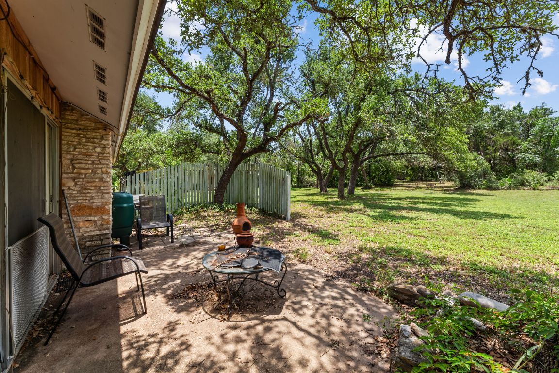 9005 Dorella Lane Austin, TX 78736 - Photo 27 of 38 a view of a backyard with table and chairs and potted plants