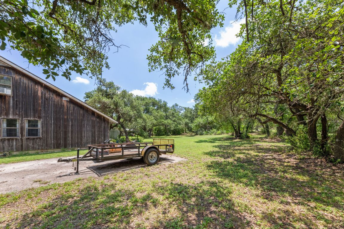 9005 Dorella Lane Austin, TX 78736 - Photo 30 of 38 a backyard of a house with a table and chairs