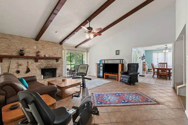 a living room with furniture a fireplace and a table