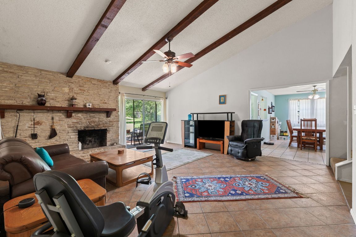 9005 Dorella Lane Austin, TX 78736 - Photo 8 of 38 a living room with furniture a fireplace and a table