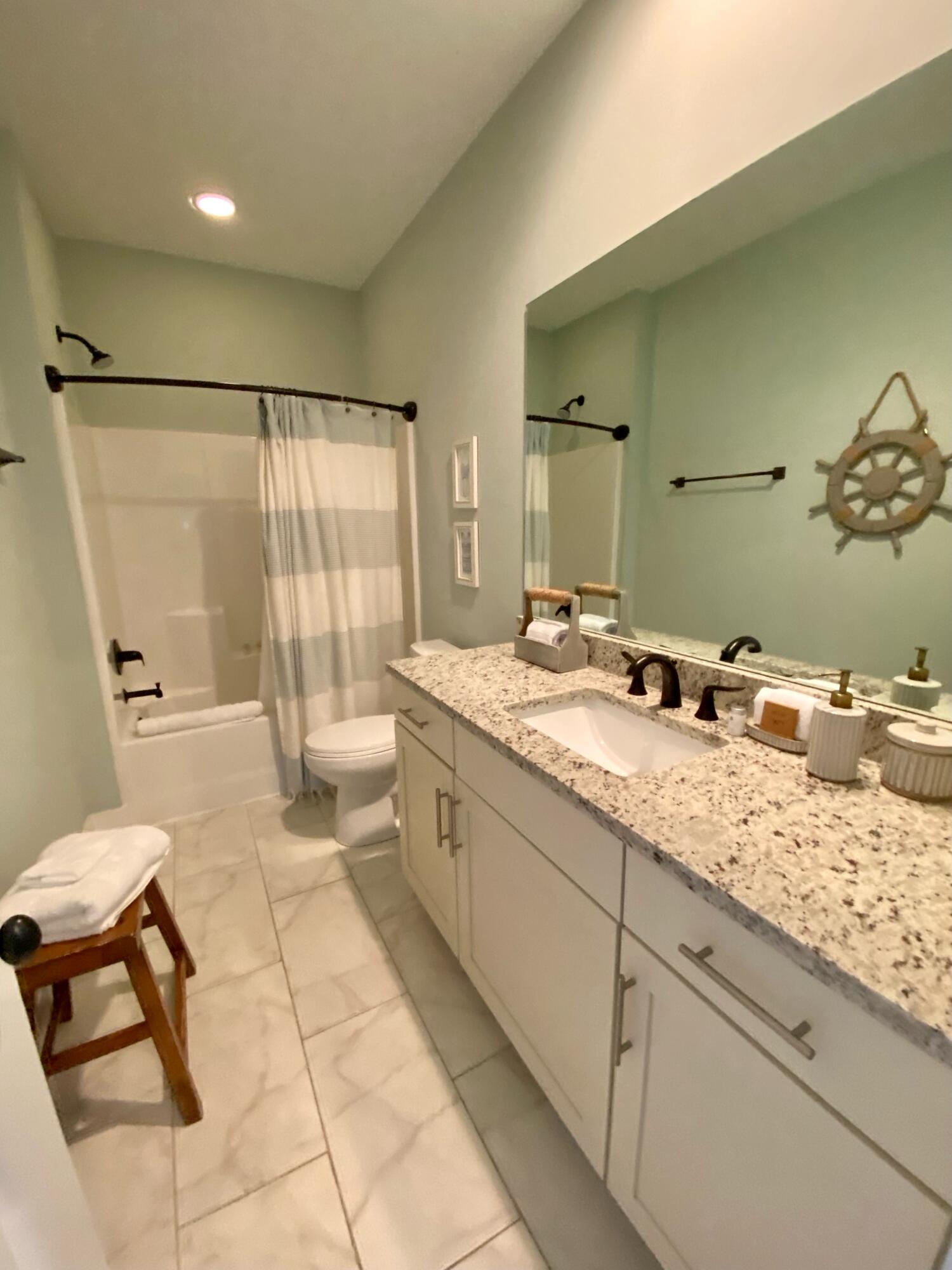 55 Valdare Way Inlet Beach Inlet Beach, FL 32461 - Photo 11 of 21 a spacious bathroom with a granite countertop sink a toilet and mirror