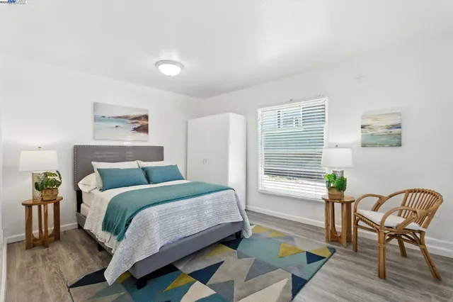 a bedroom with a bed chair and window