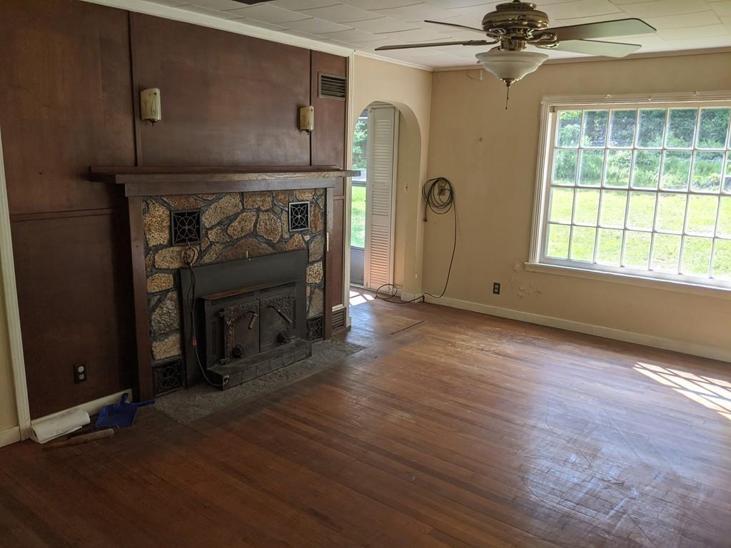 58 North Monson Road Hampden, MA 01036 - Photo 5 of 25 wooden floor and fireplace in livingroom with window