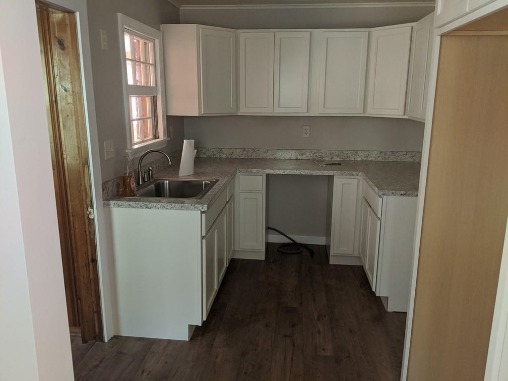 58 North Monson Road Hampden, MA 01036 - Photo 7 of 25 a kitchen with a sink stove and cabinets