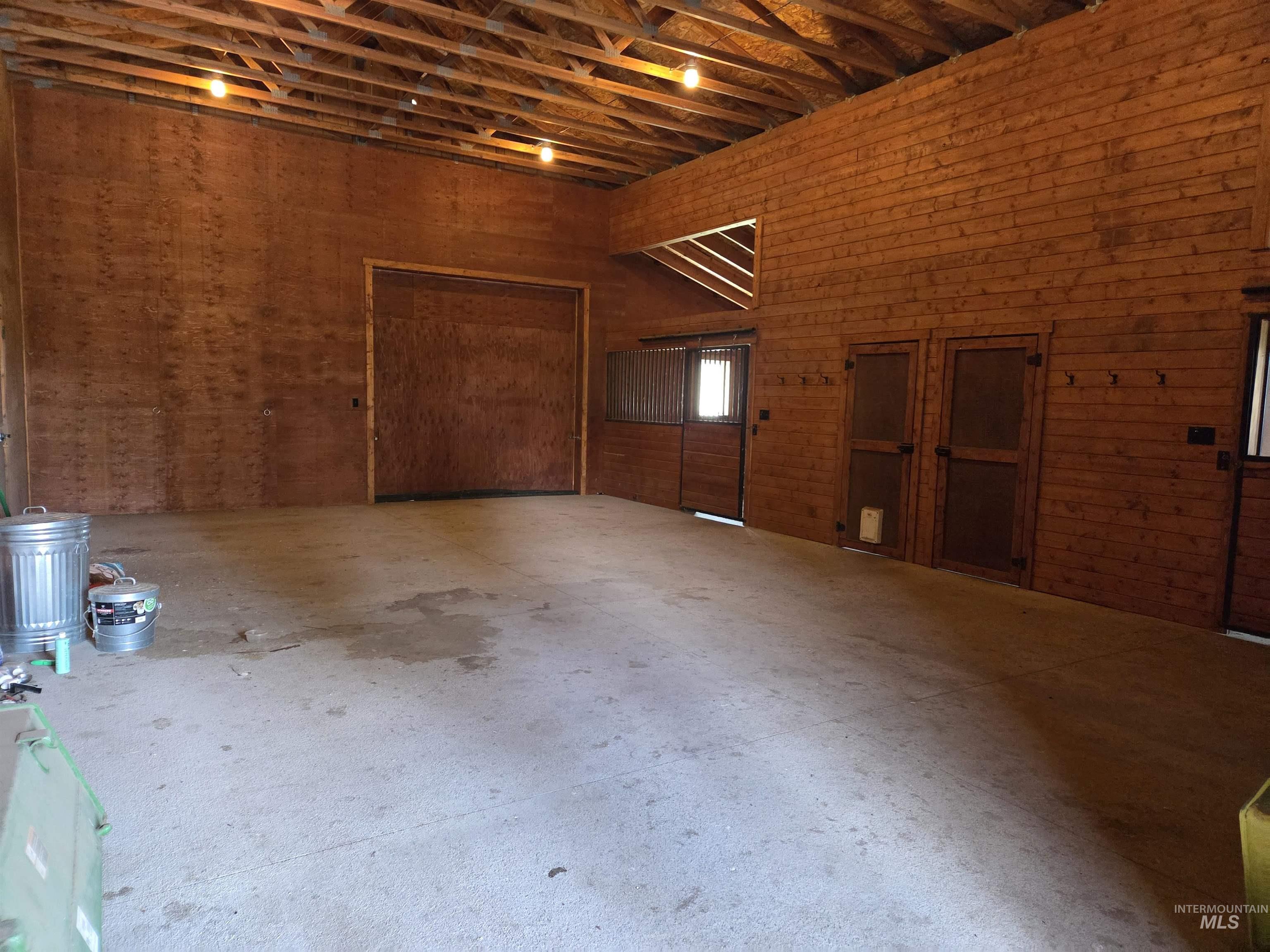 1085 Wallen Road Moscow, ID 83843 - Photo 38 of 50 Spacious interior featuring exposed beam ceilings, wood-paneled walls, and concrete flooring