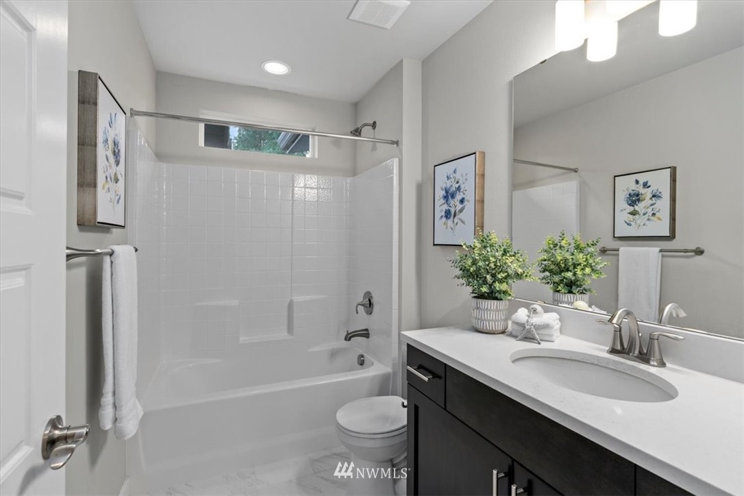 521 238th Place Southeast, Unit B Bothell, WA 98021 - Photo 20 of 21 a bathroom with a granite countertop sink toilet and shower