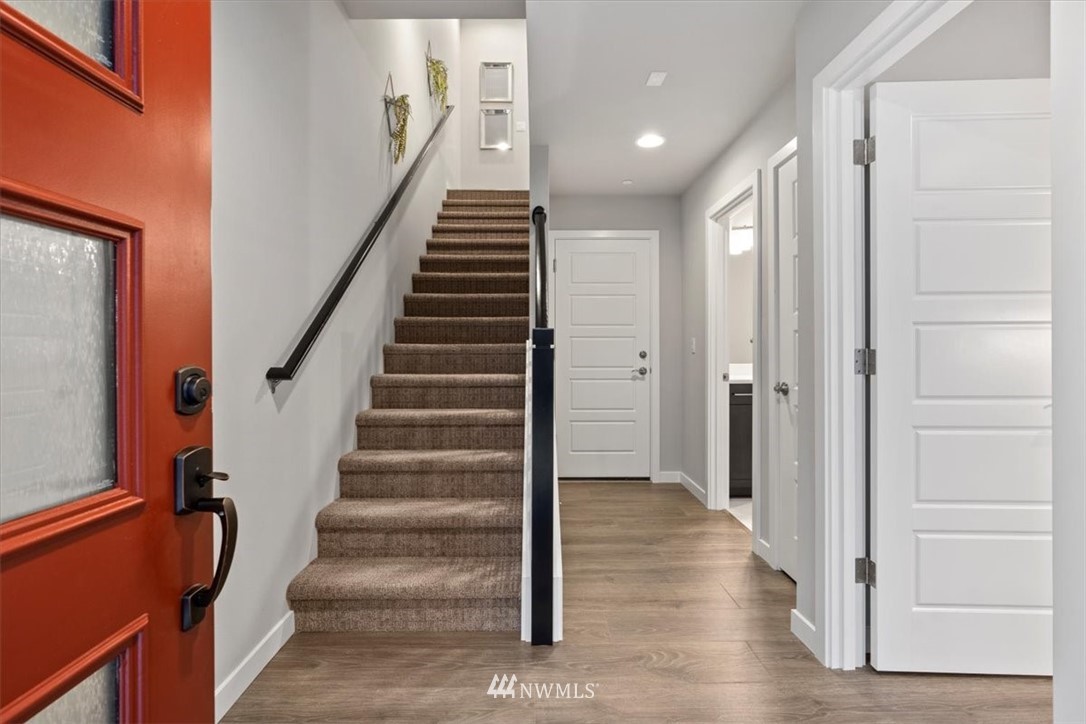 521 238th Place Southeast, Unit B Bothell, WA 98021 - Photo 6 of 21 a view of a hallway with wooden floor and entryway