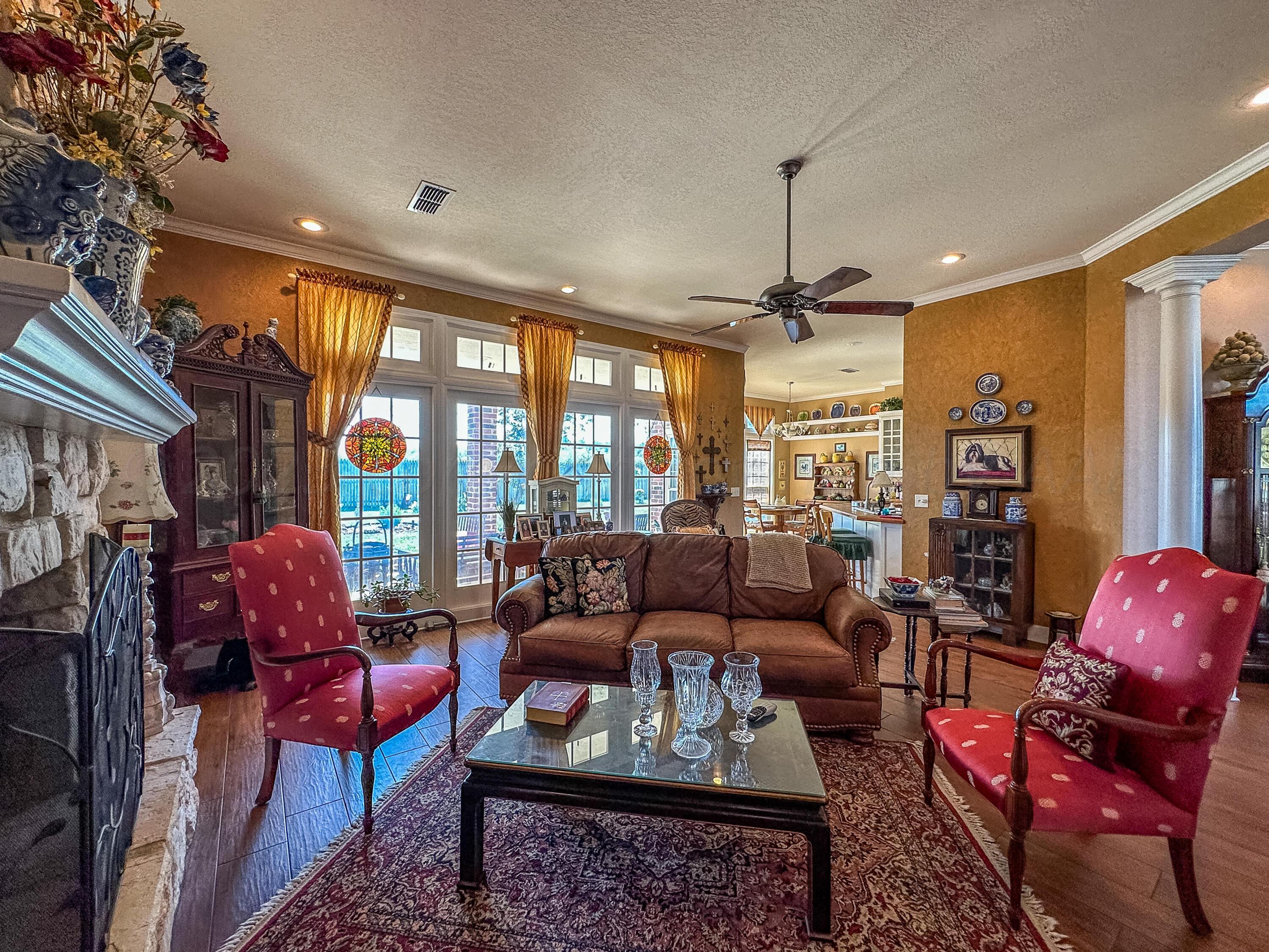 105 St James Street Borger, TX 79007 - Photo 14 of 36 a living room with furniture a rug and a chandelier