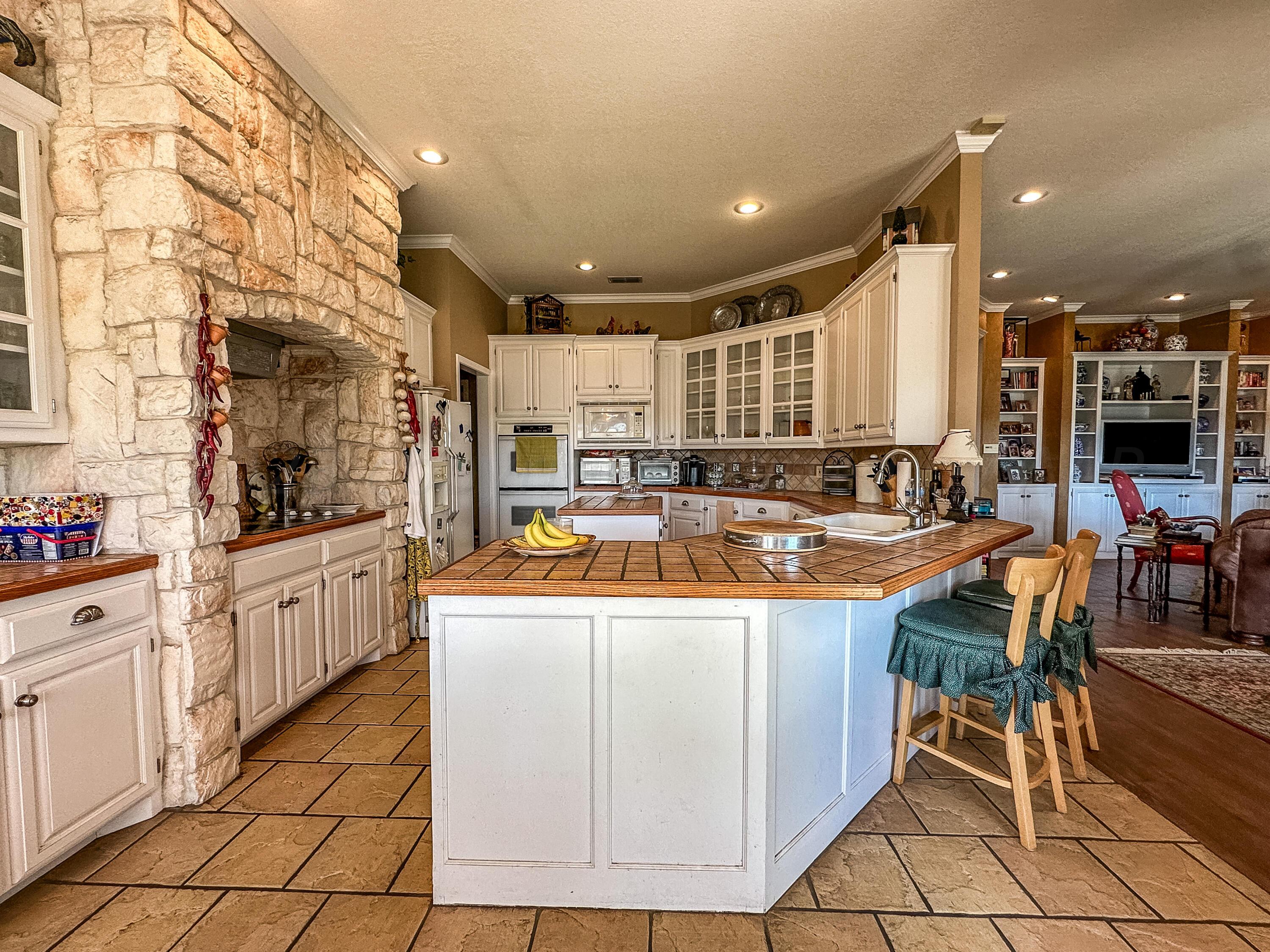 105 St James Street Borger, TX 79007 - Photo 17 of 36 a kitchen with stainless steel appliances granite countertop a sink and a refrigerator