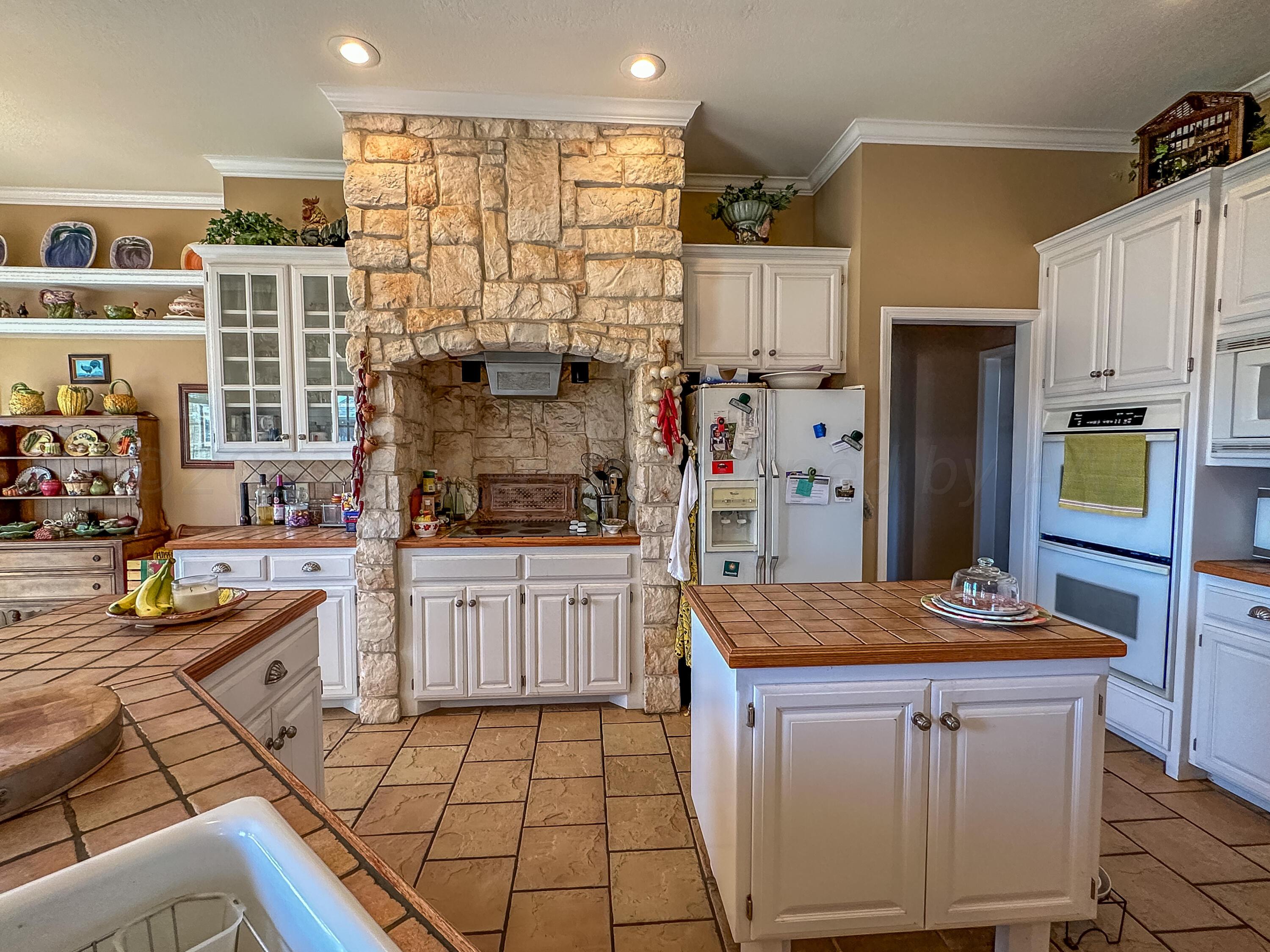 105 St James Street Borger, TX 79007 - Photo 19 of 36 a kitchen with stainless steel appliances granite countertop a sink and cabinets