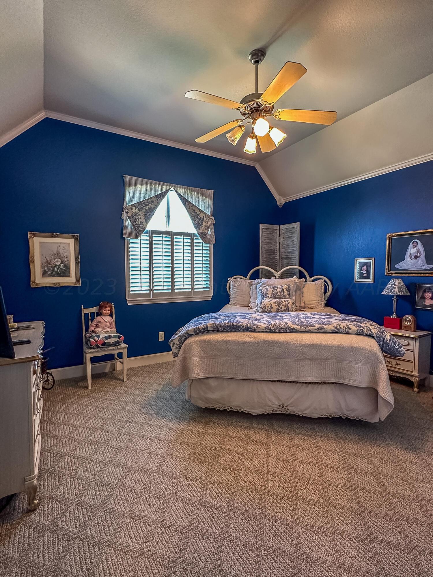 105 St James Street Borger, TX 79007 - Photo 26 of 36 a bedroom with a large bed and a chandelier