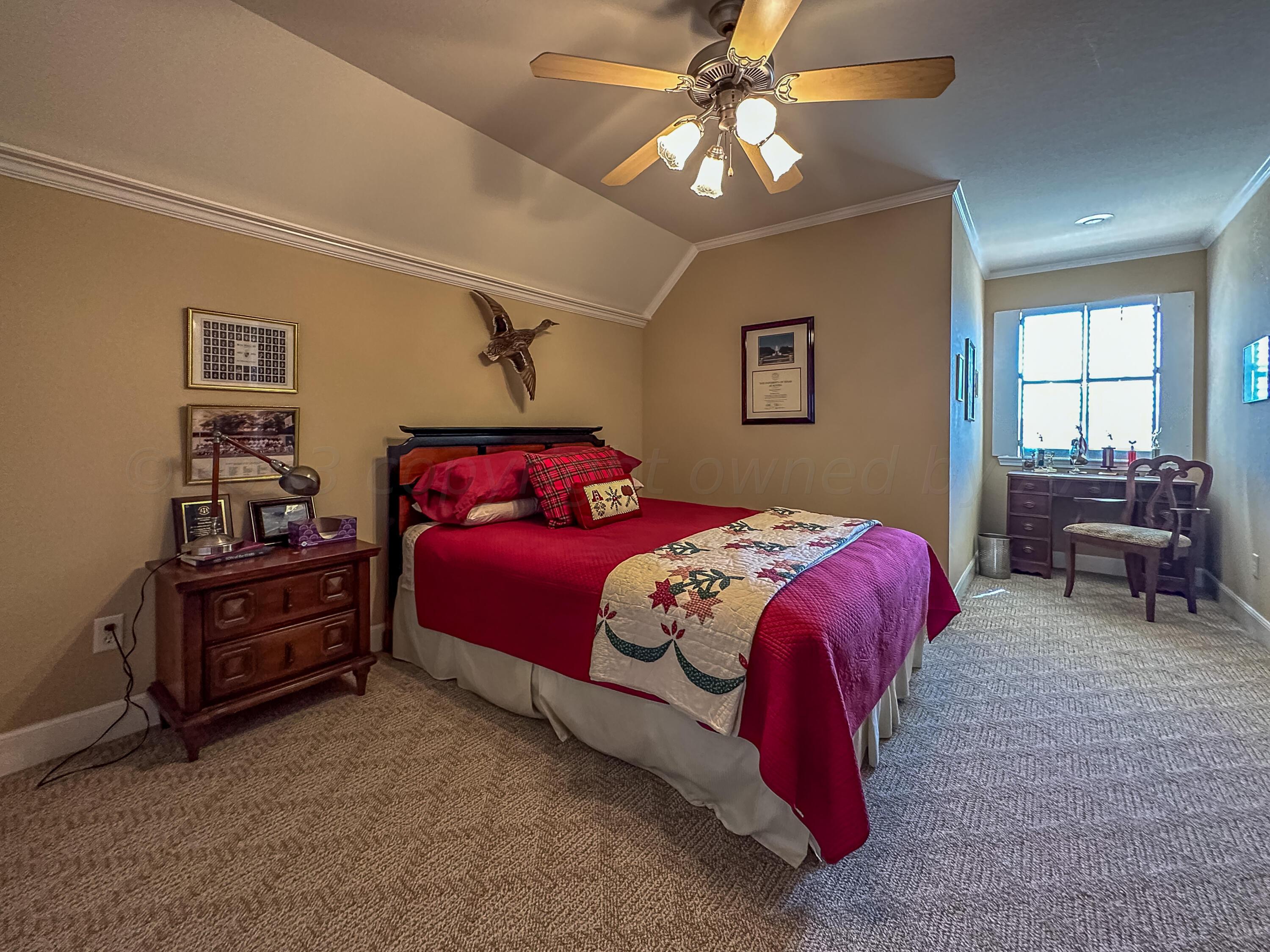 105 St James Street Borger, TX 79007 - Photo 31 of 36 a bedroom with a bed and a chandelier