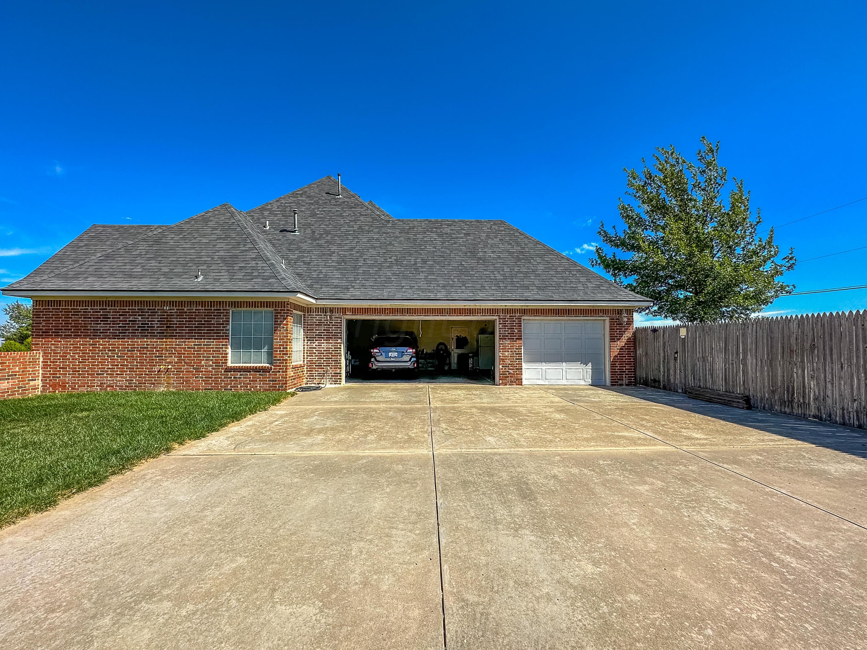 105 St James Street Borger, TX 79007 - Photo 36 of 36 a front view of a house with a yard and garage