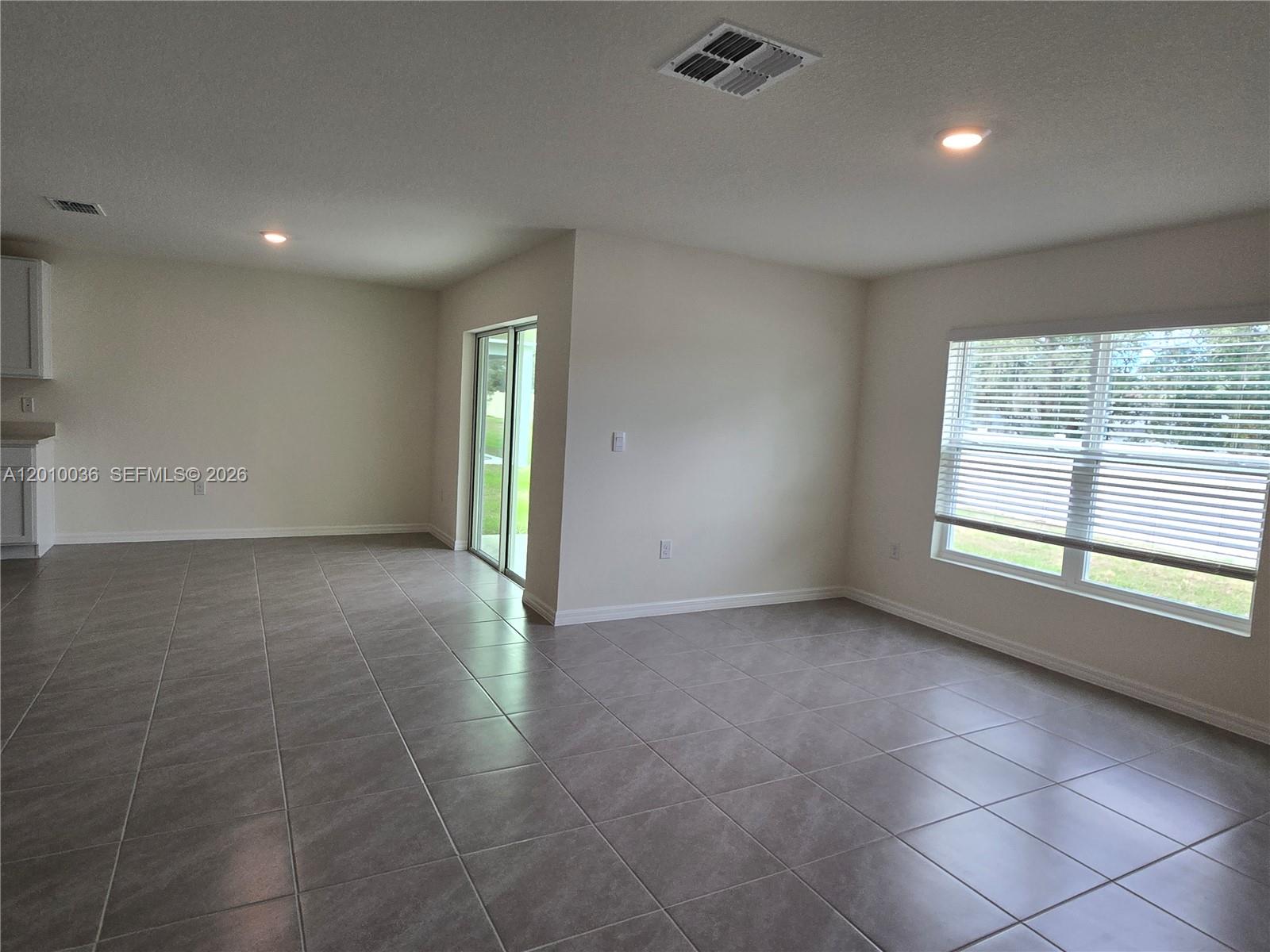 9871 Southeast 161st Lane Road Summerfield, FL 34491 - Photo 21 of 31 an empty room with a empty space and windows